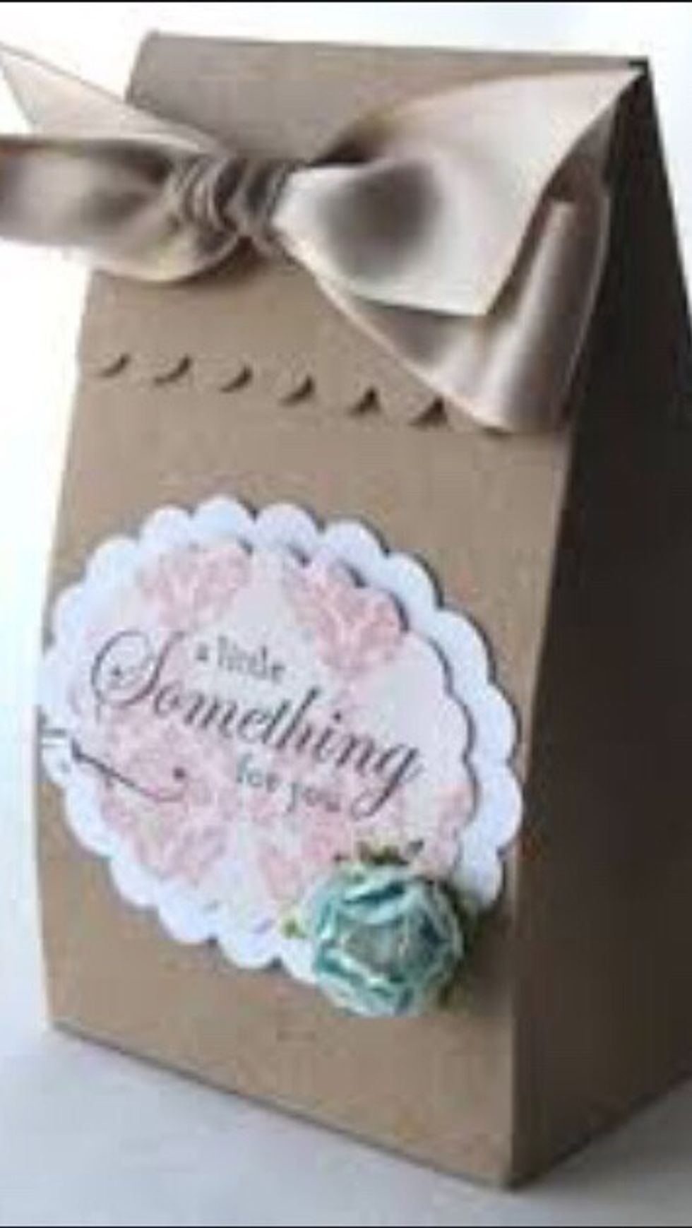 Use your own materials. Brown craft paper, ribbon and glued on embellishments.