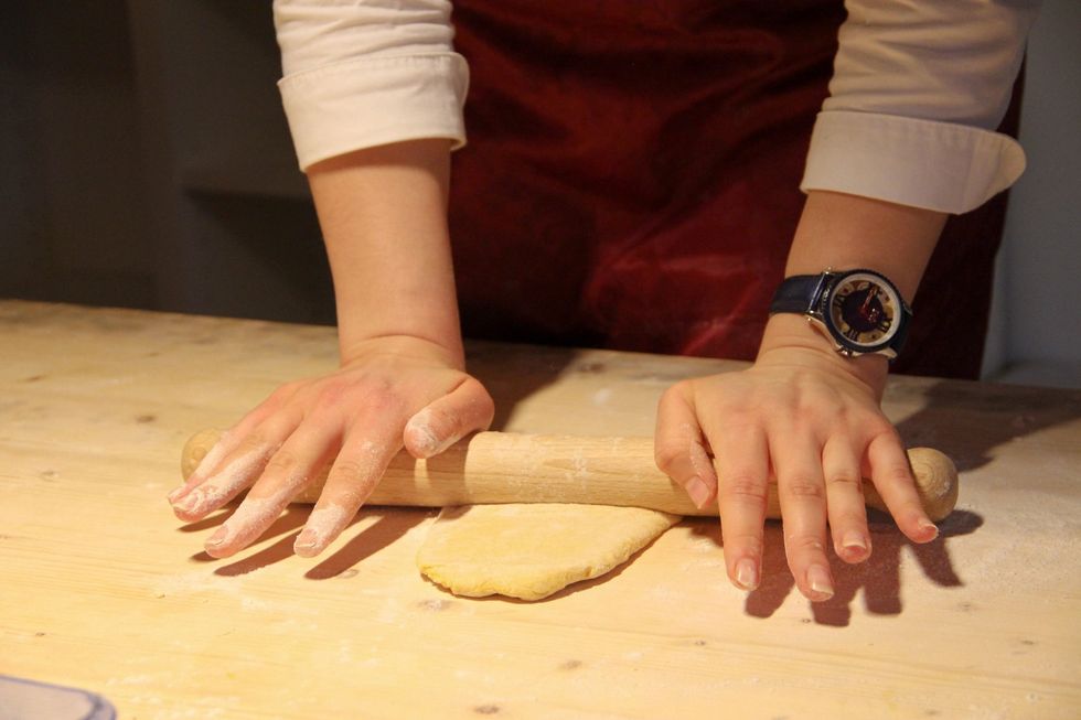 Use your pin roll and start flattening your dough.