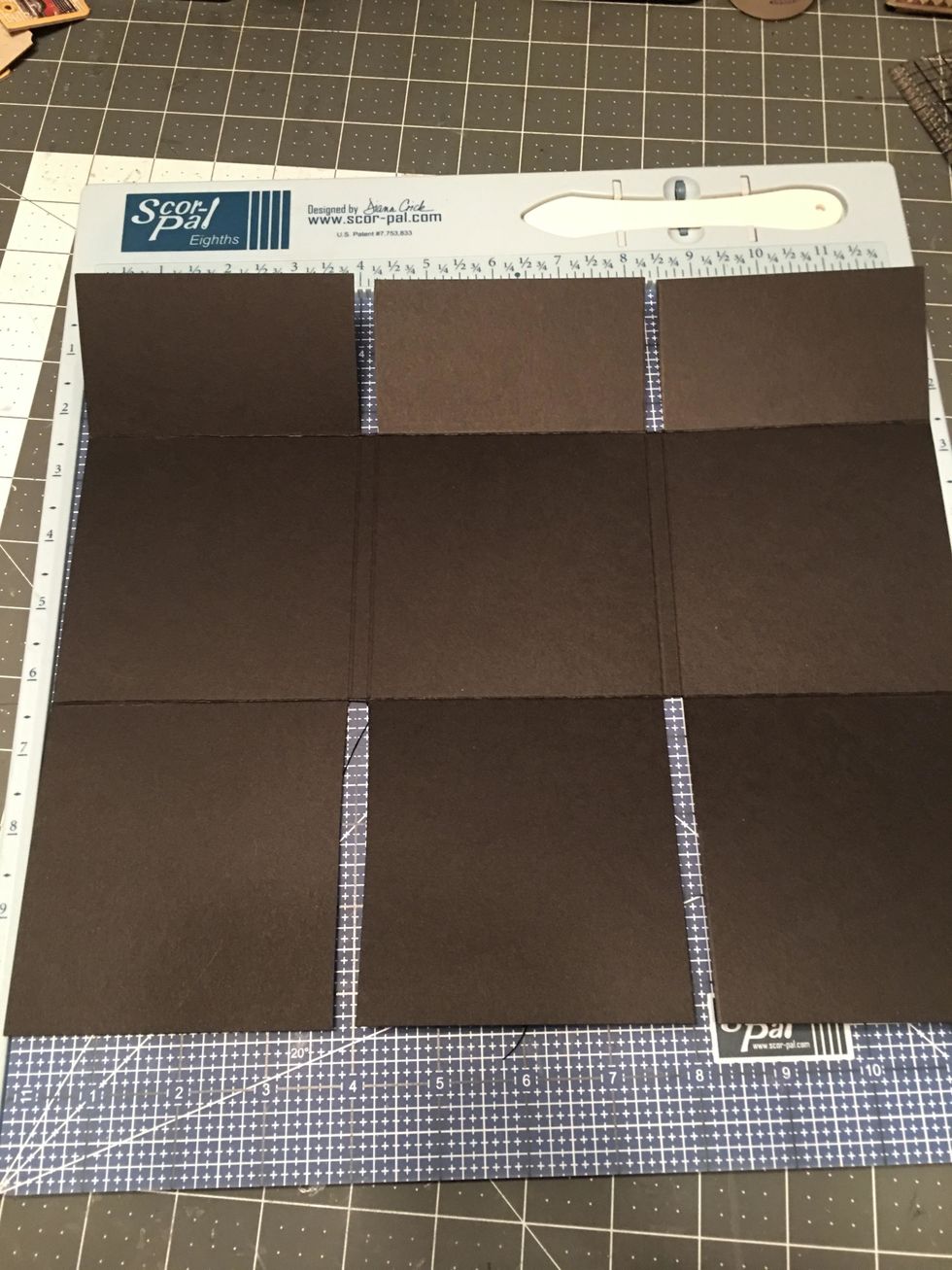 Use your scissors to cut out the 1/4" spaces on the top and the bottom as shown in this photo. Only cut up to the score lines of the center sections.