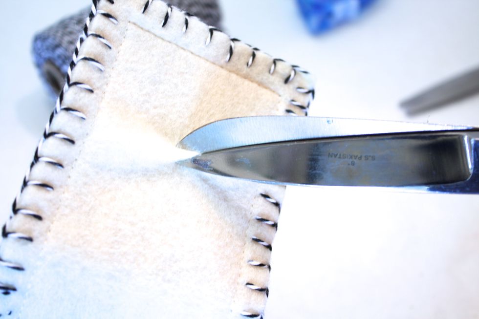 Use your scissors to make a little snip on the outside of your needle holder- dont snip the paper!