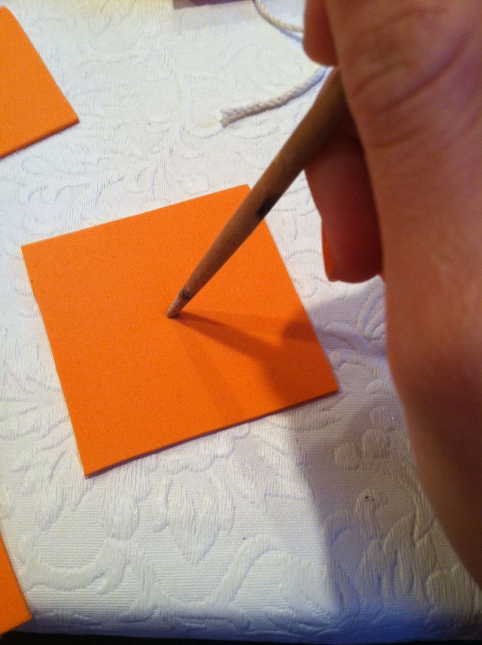 Use your tool to poke a hole through the middle of the square.