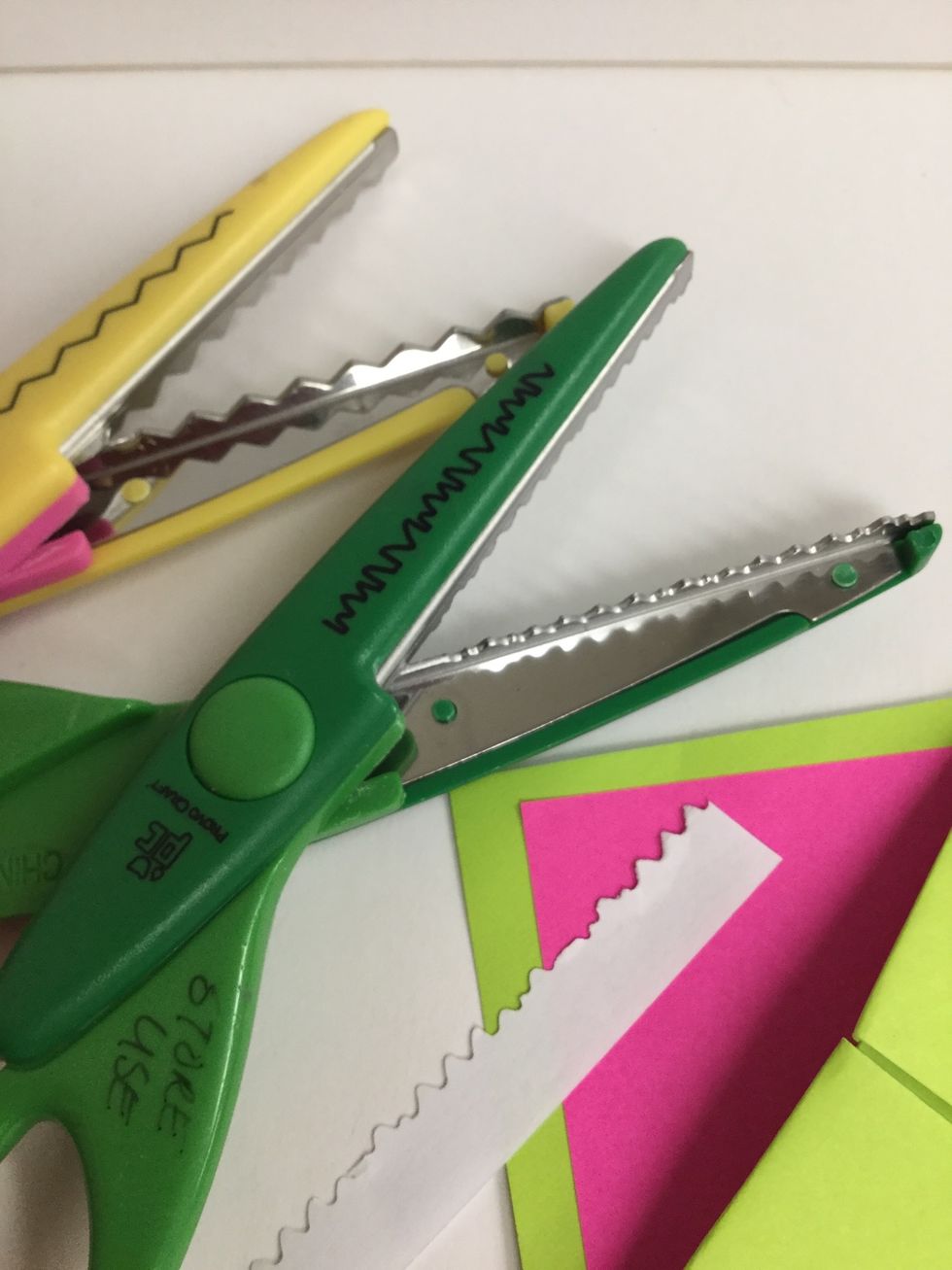 Used decorative scissors to cut a 1/2 inch wide strip of white paper for the monster's teeth.