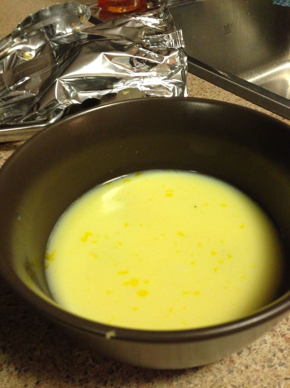 Using 1 large egg, scramble in a bowl and add milk, then stir until fully mixed.