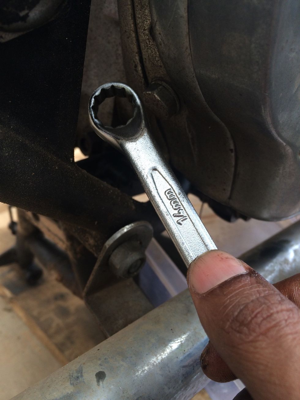 Using 14mm spanner or socket wrench remove the level indicator bolt.