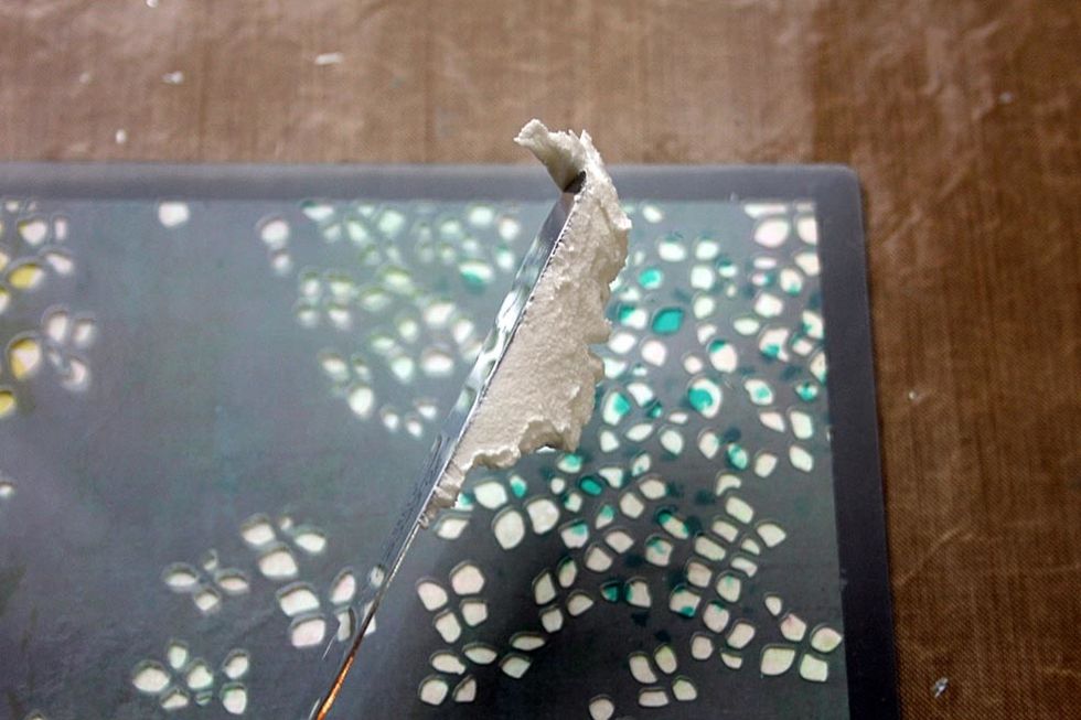 Using 579890 \u2013 Fluttering Flowers Stencil- spread light paste across the stencil with palette knife. Allow to dry.