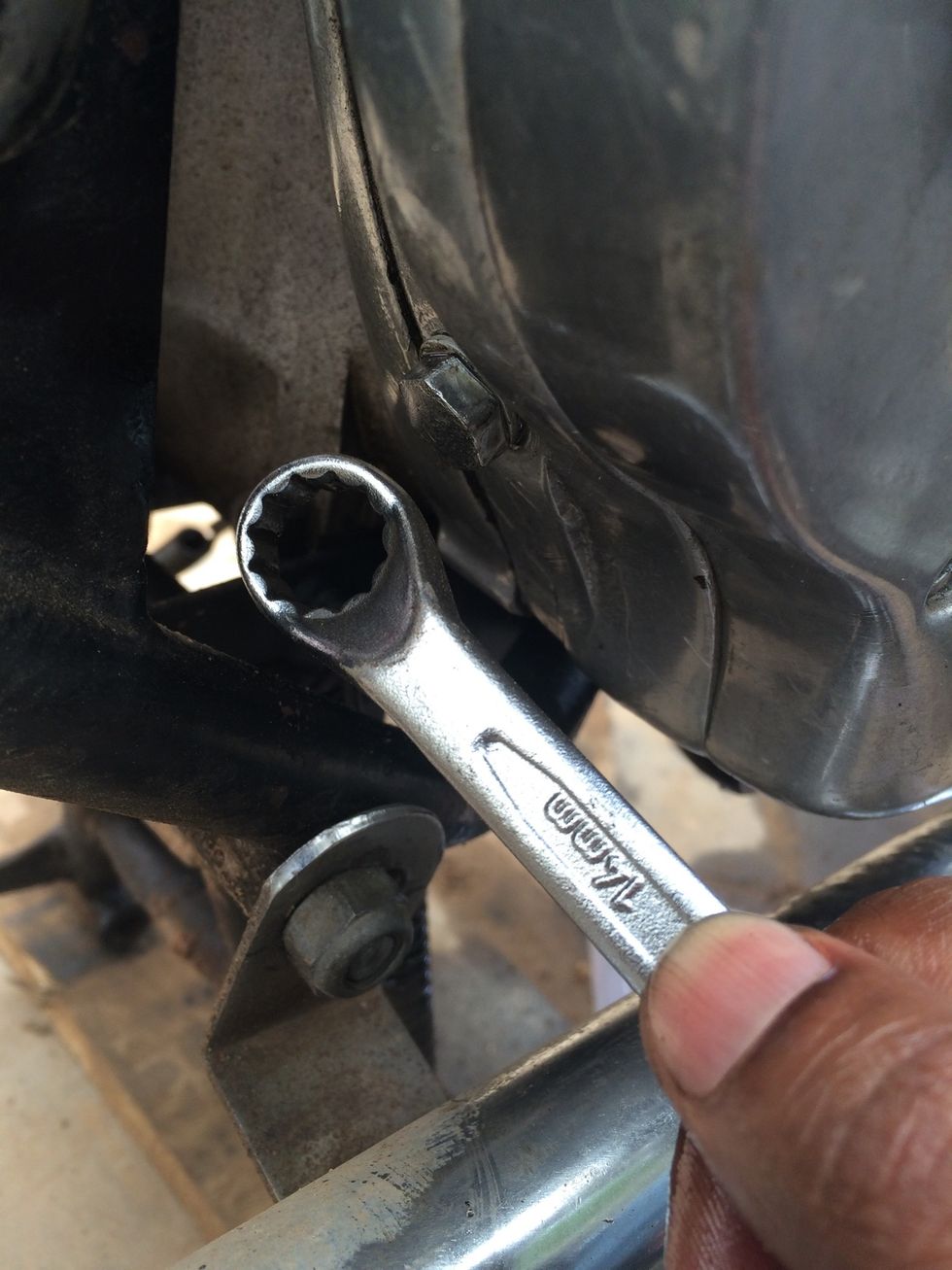 Using a 14mm spanner or wrench