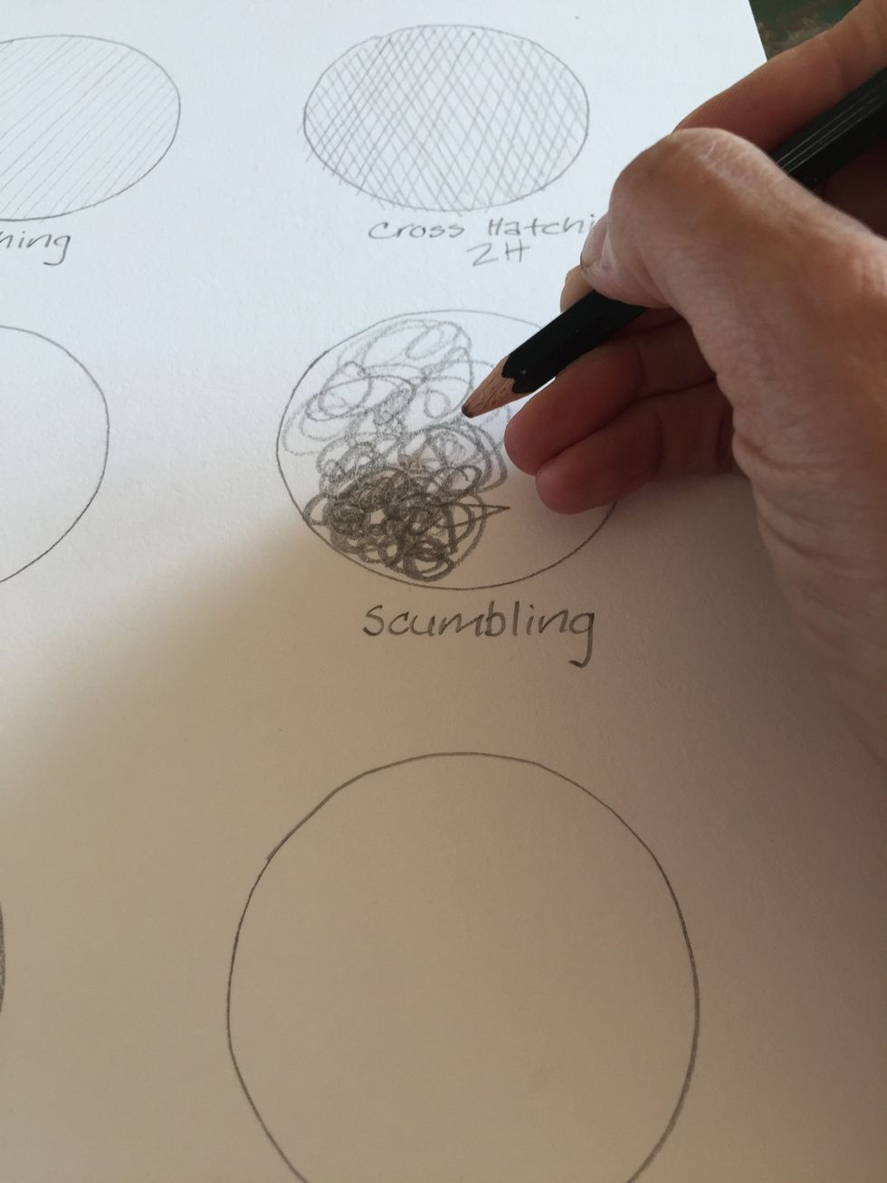 Using a B pencil dribble in a circular way. Close together scribbles make for dark shading and scribbles that are farther apart create lighter areas