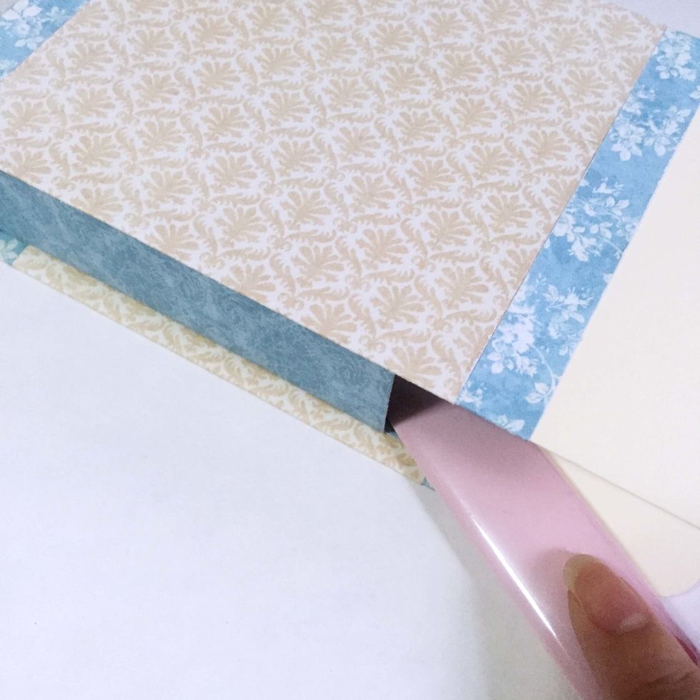 Using a bone folder, gently burnish the interior of the box to ensure the surfaces are well-stick together.
