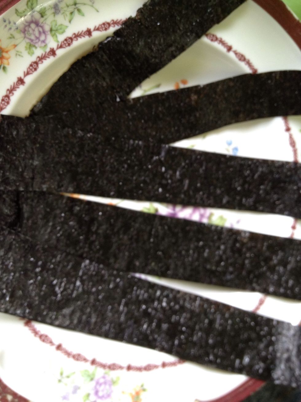 Using a clean scissors, cut the nori (seaweed) like this