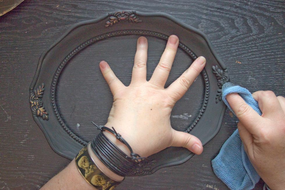 Using a damp cloth, "wet distress" any ornamental details on the frame: