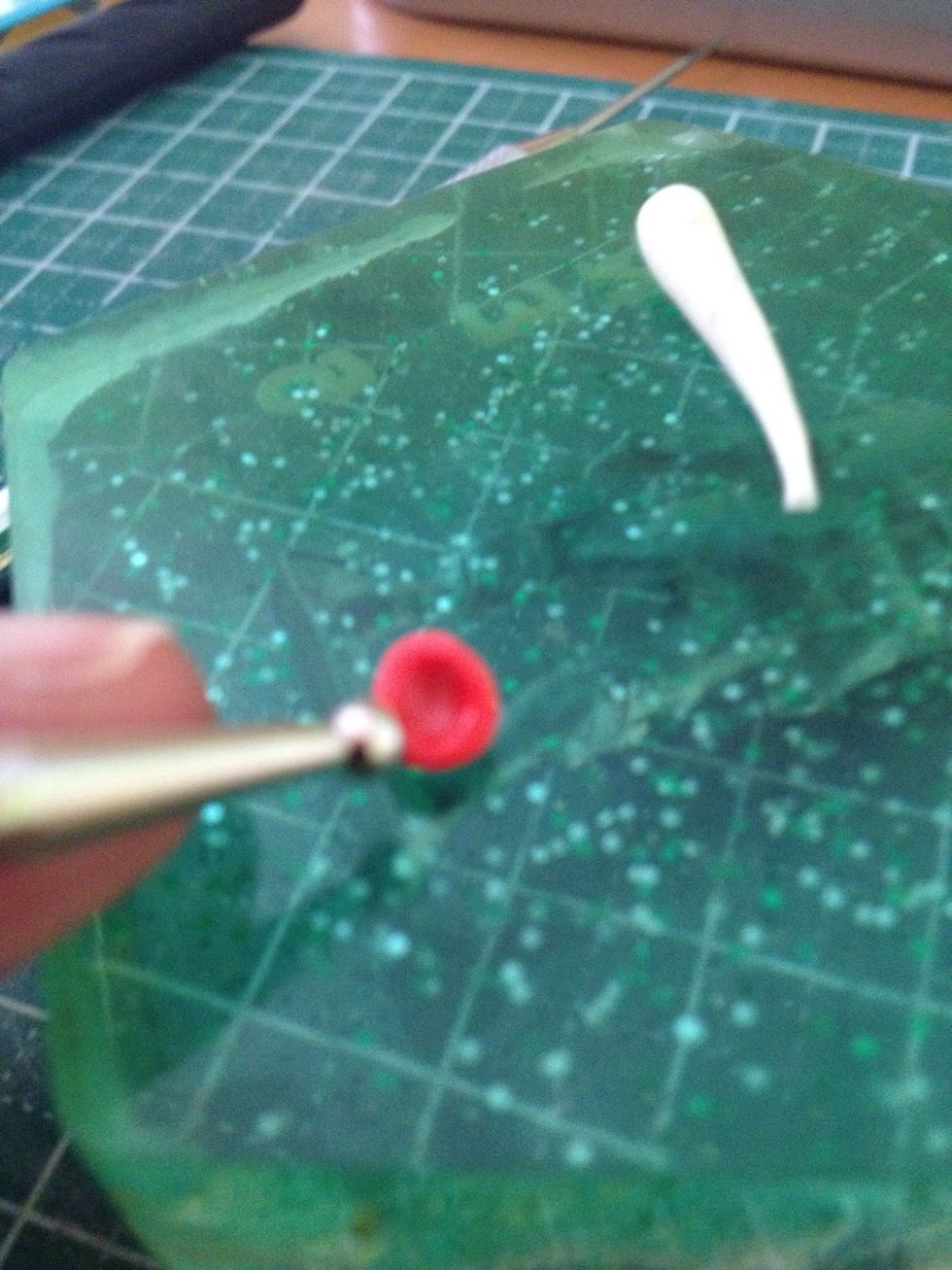 Using a dotting tool, invert the mushroom cap and do as shown, creating its shape.