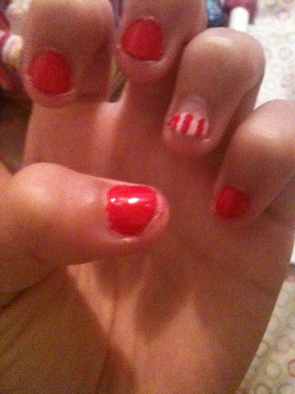 Using a dotting tool make red stripes on the pink polish