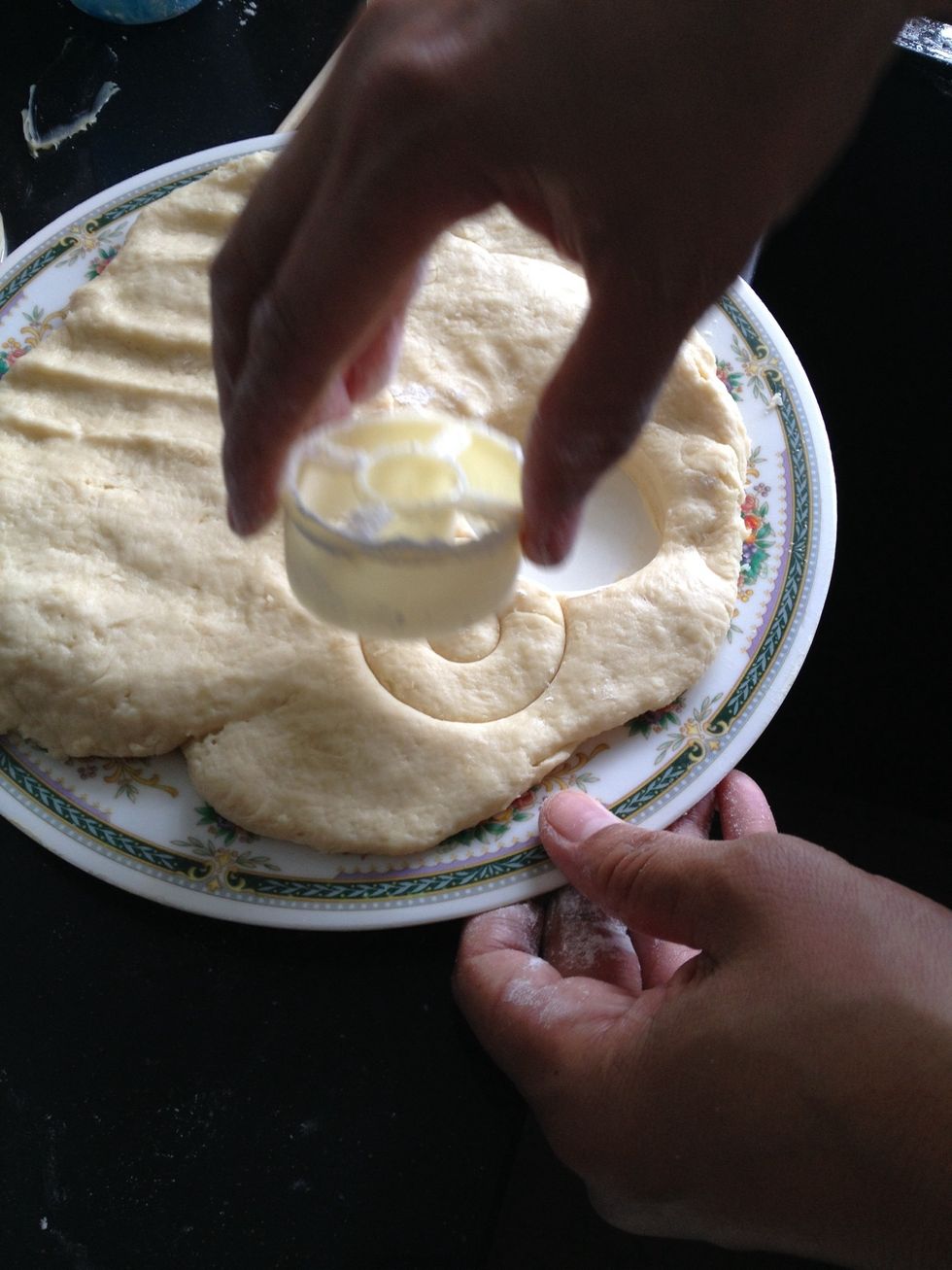 Using a doughnut cutter, pressed it on the dough.