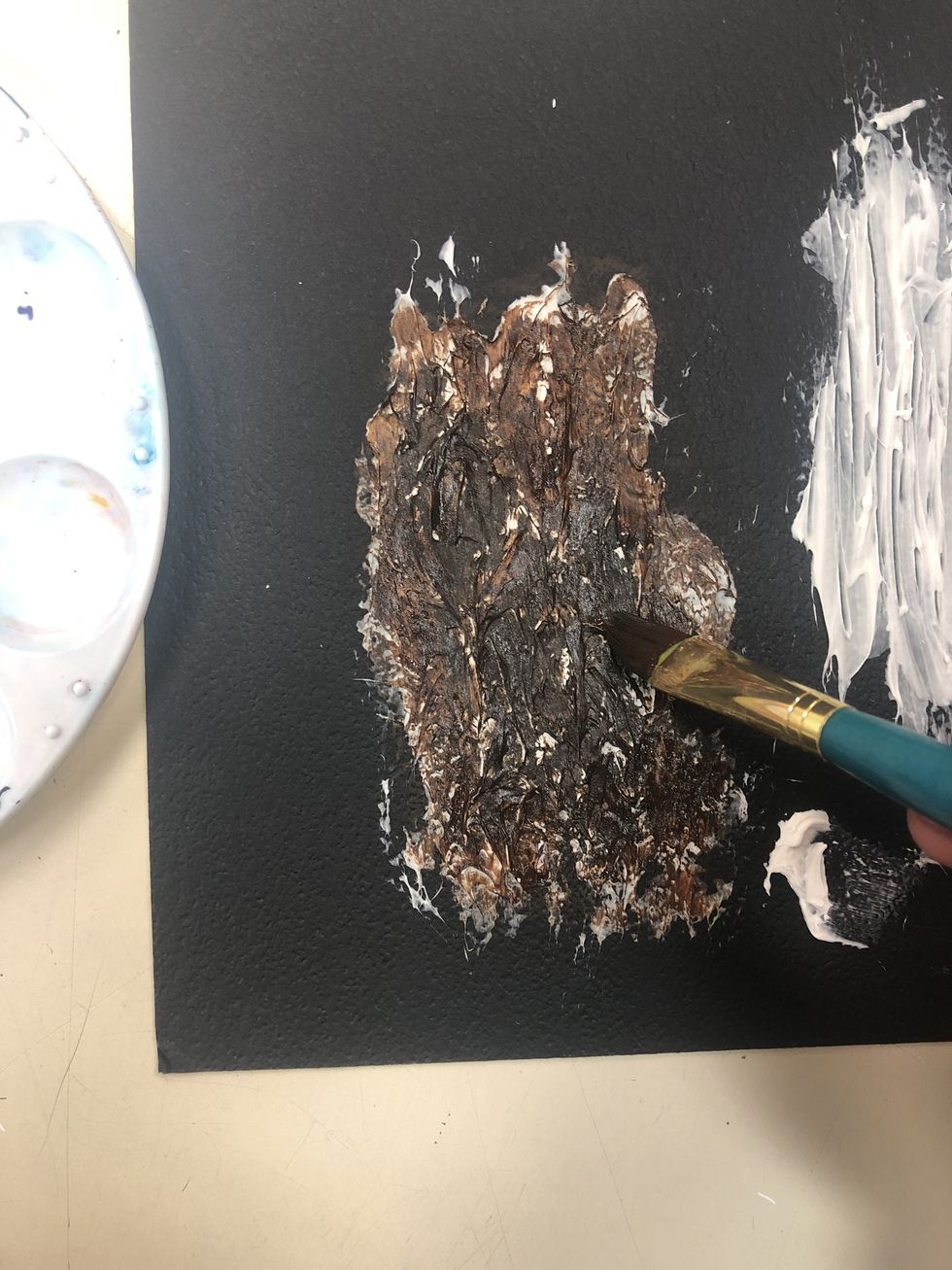 Using a dry brush, paint on an initial layer of dar brown paint. It is okay if not all of the parts are covered. Allow to dry for next step.
