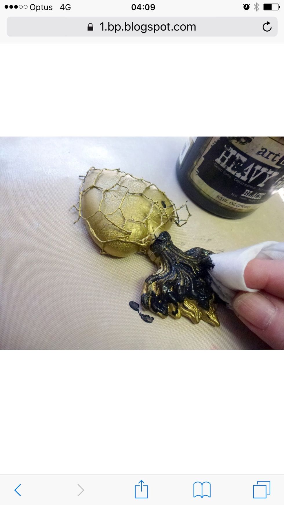 Using a dry soft wet wipe apply black gesso to flame resin, and allow to partially dry.