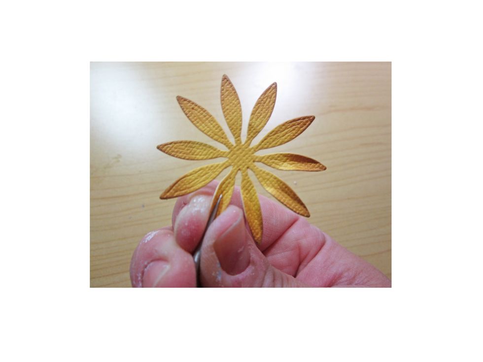 Using a fine pair of tweezers pinch each of the petals to add depth.