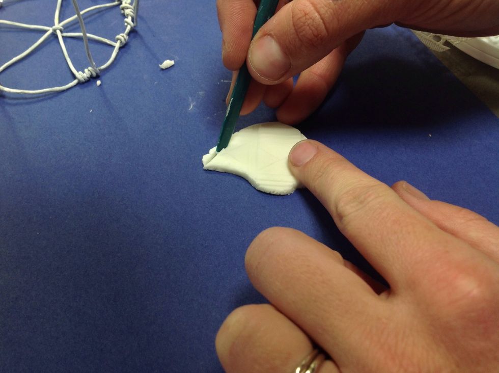 Using a flat tool, like a butter knife, carve the shape of your bird. Mine is super simple and a little larger than a quarter. Mine is flat, but make yours however you want.