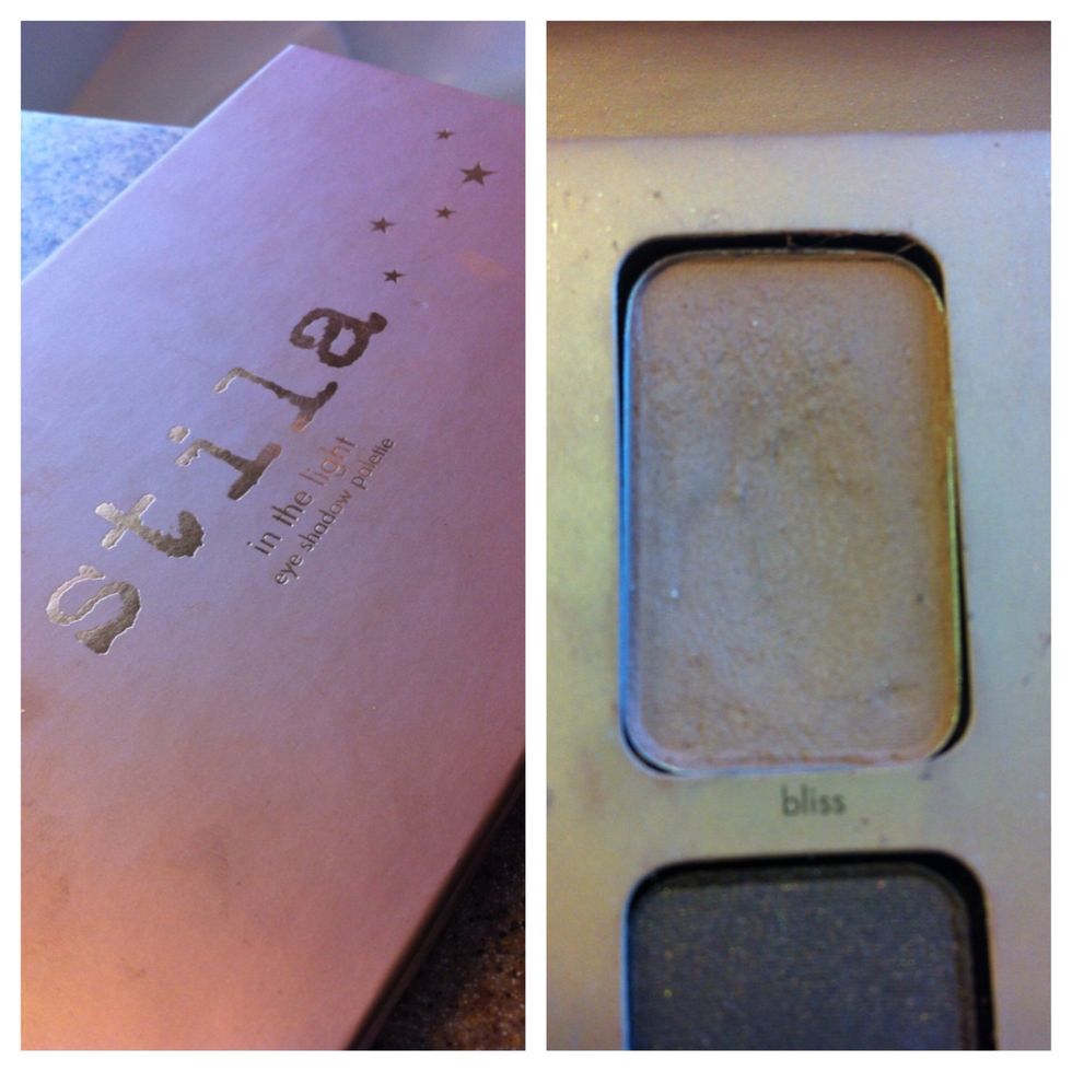 Using a fluffy brush, sweep a matte caramel shade onto the lid. I'm using the color "Bliss" from the Stila "in the light" palette.
