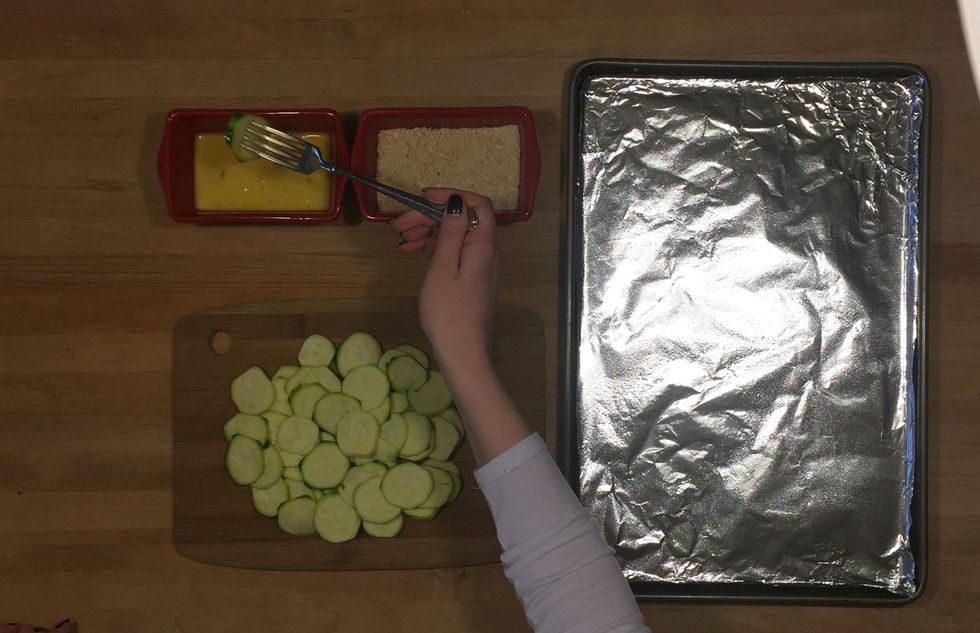 Using a fork, dip slices into egg mixture, making sure it covers the whole slice.  (Let the excess fall off before going on so it doesn't go into the other mixture.)
