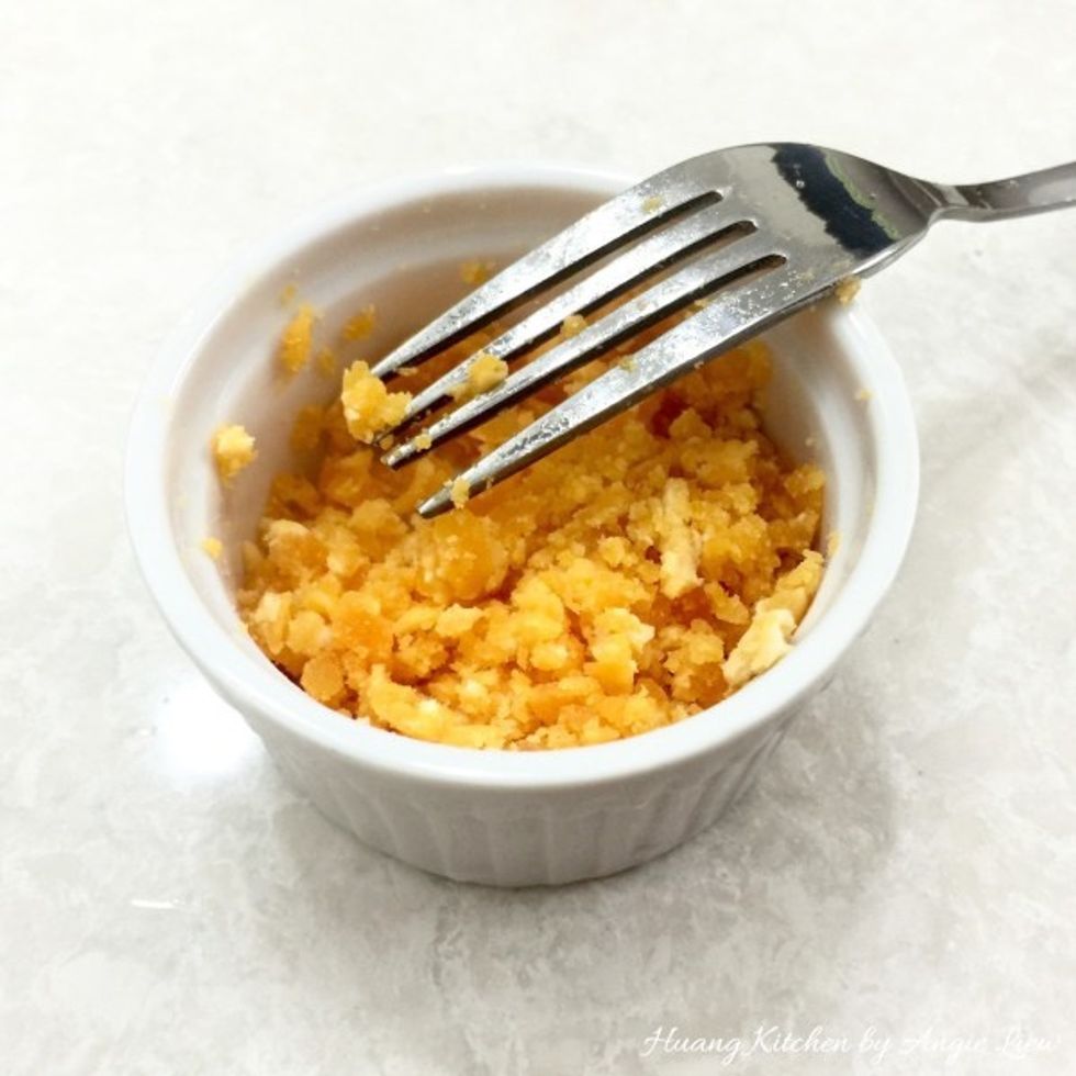 Using a fork, mashed the cooked salted egg yolks. Now, we are ready to stir fry the bitter gourd.