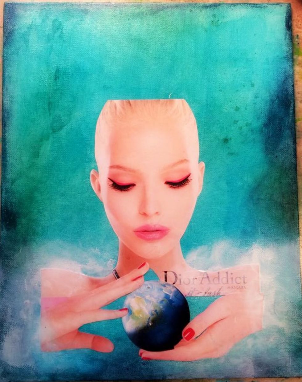 Using a gel medium apply your collage items. I put the gel medium directly on the painted board. Carefully lay down your image and use a credit card to get out any bubbles or wrinkles.