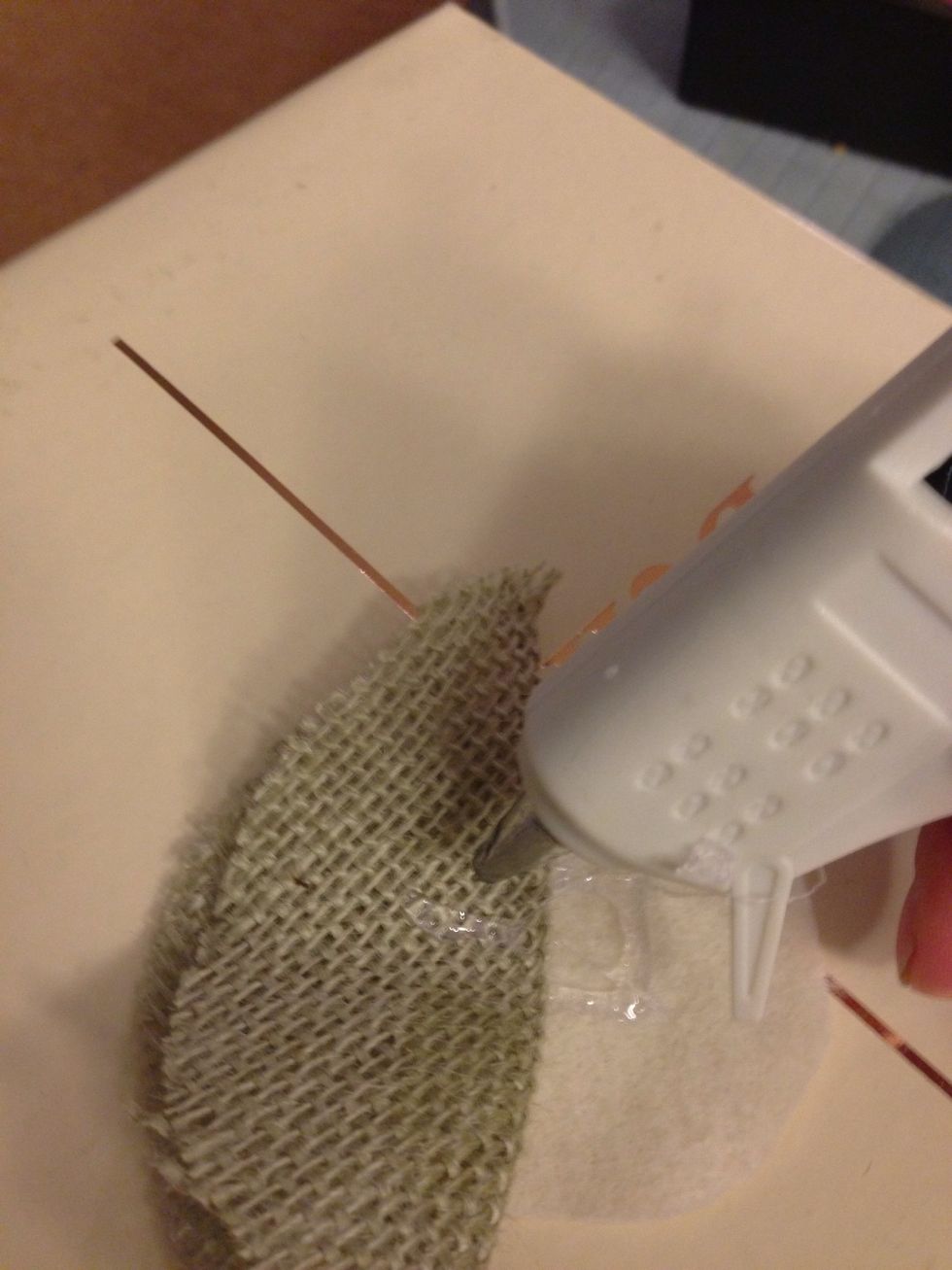 Using a glue gun, secure to the felt. I usually tack with glue on the inside of the second fold as well as directly onto the felt.