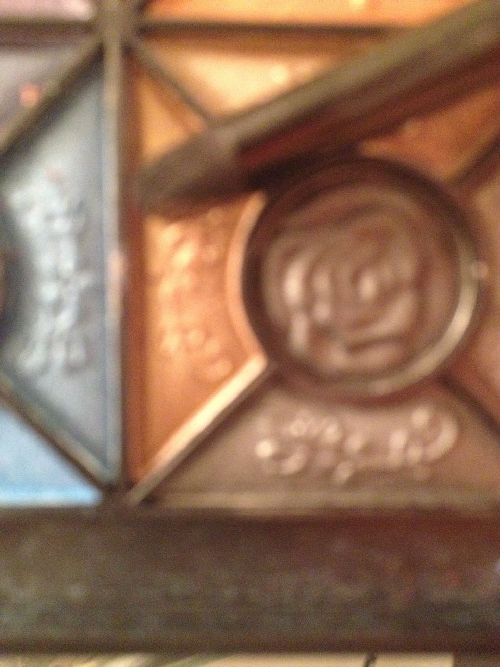 Using a gold eyeshadow we are going to pick it up with our domed eyeshadow brush and begin sweeping it into our crease