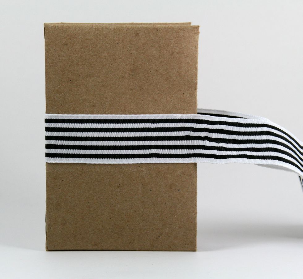 Using a good strong adhesive wrap and attach wide striped ribbon.