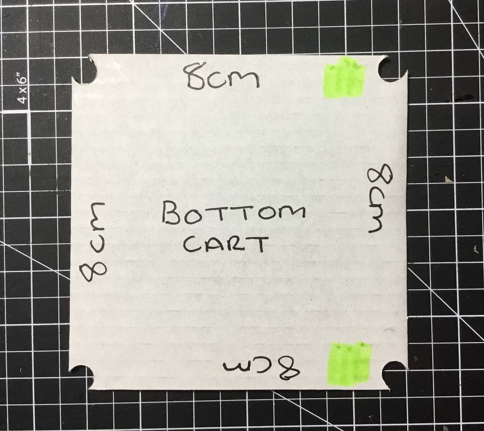 Using a hole punch, punch each corner of the cart base as shown.