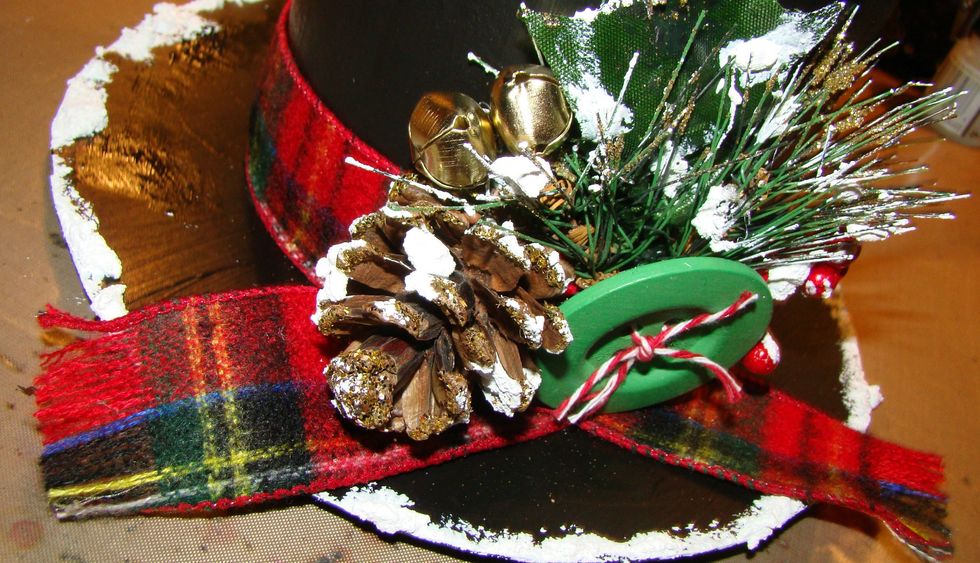 Using a hot glue gun, attach your florals, buttons, bells etc.