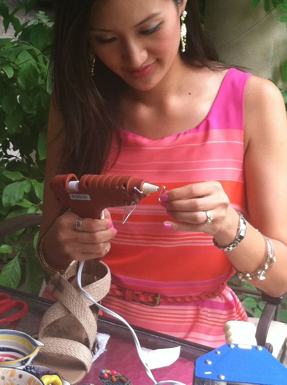 Using a hot glue gun, glue a safety pin with a base to the leaves