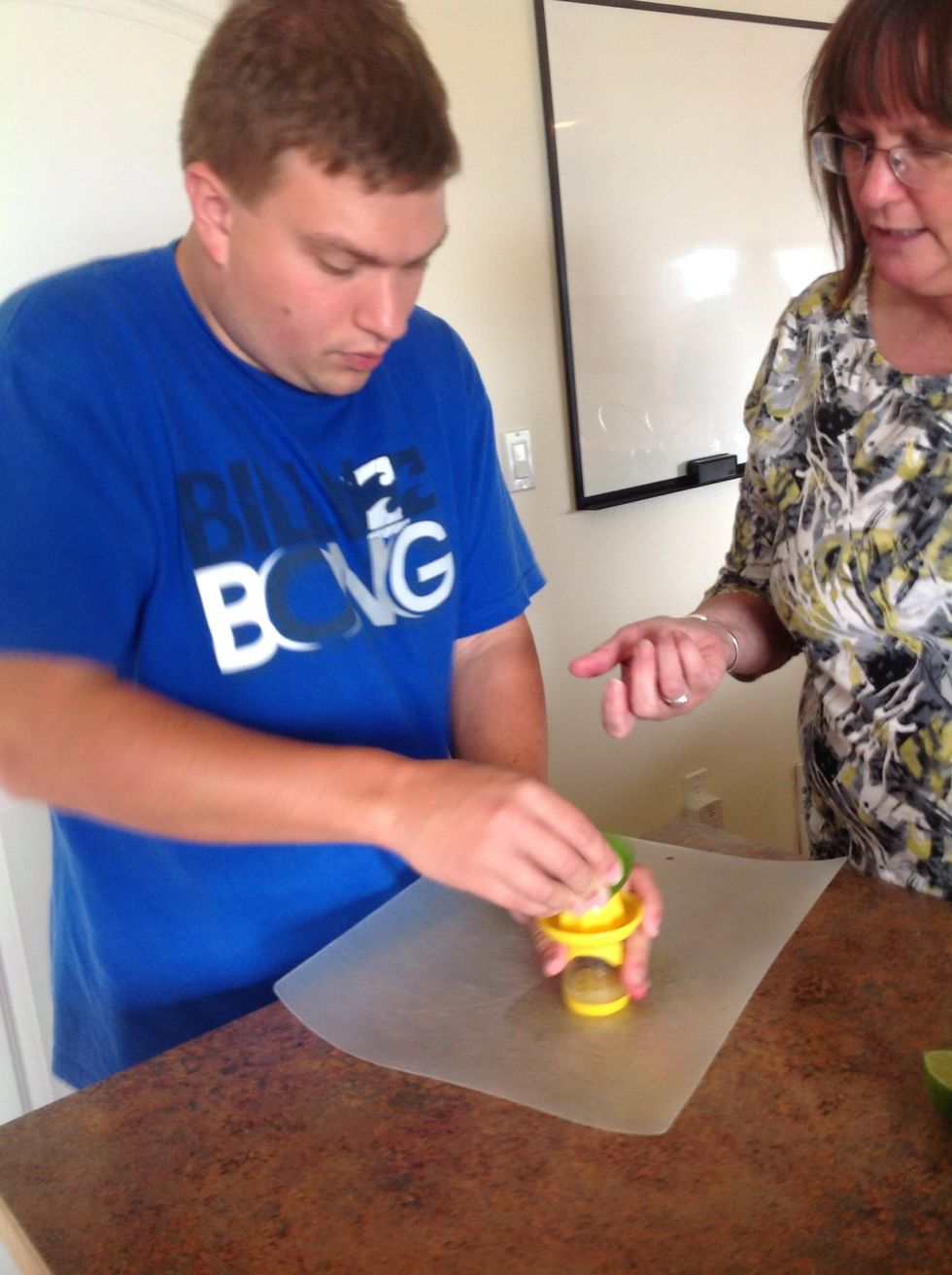 Using a juicer juice the two limes