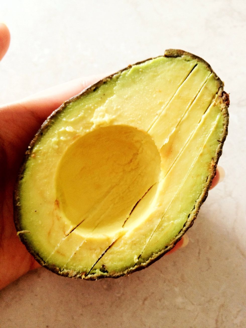 Using a knife, carefully slice your avocado. I am using 1/4 of a large avocado.