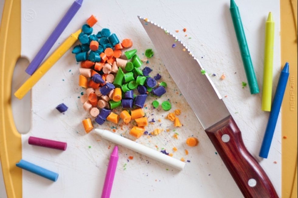 Using a knife, chop your crayons so that they fit into mini baking liners. Preheat your oven to 325, and place your chopped crayon mixtures into different color assortments.