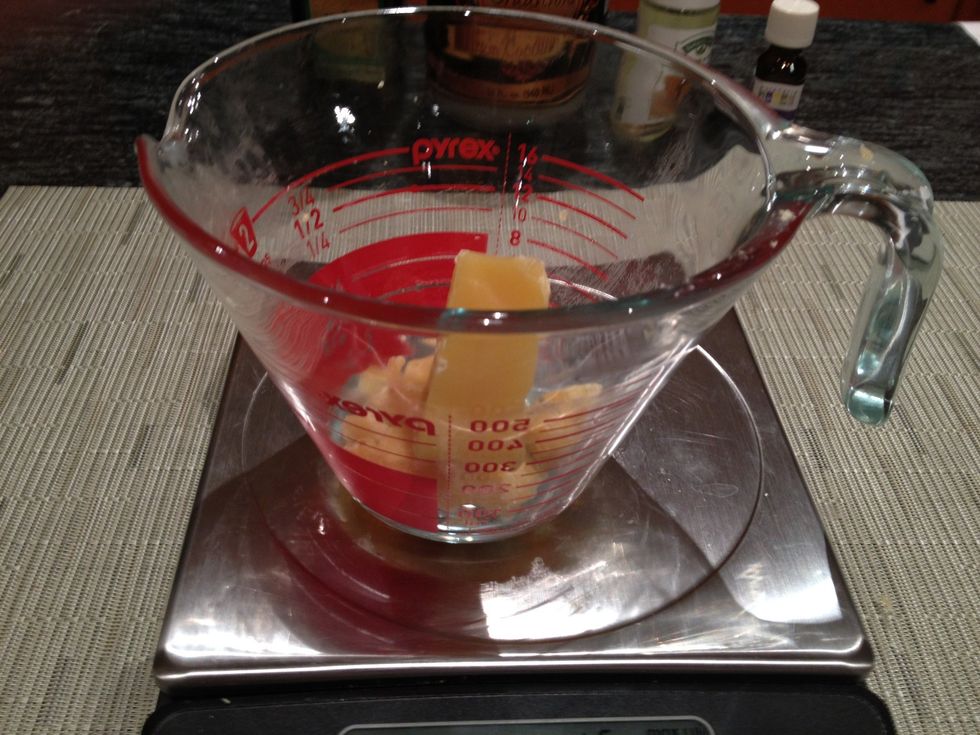 Using a knife or a grater, measure 2 ounces of the beeswax. If you have an electronic scale, place your Pyrex measuring cup on the scale, and zero it out. Then add the beeswax.