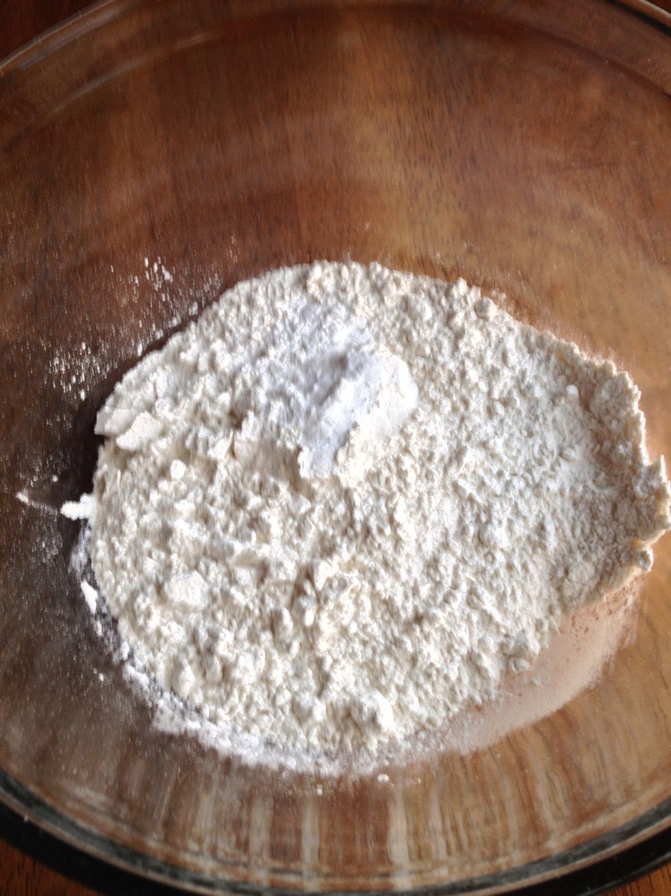 Using a large bowl, mix flour, baking soda, baking powder, and salt.
