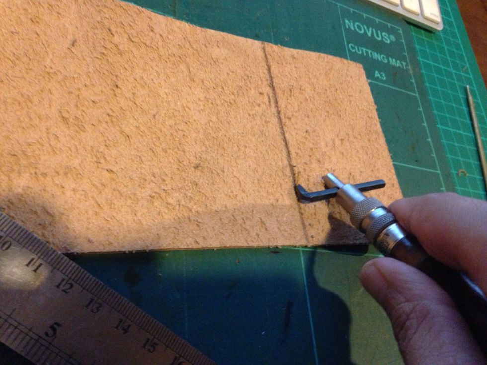 Using a leather groover scrap the both line until it is thin so it can be fold easily