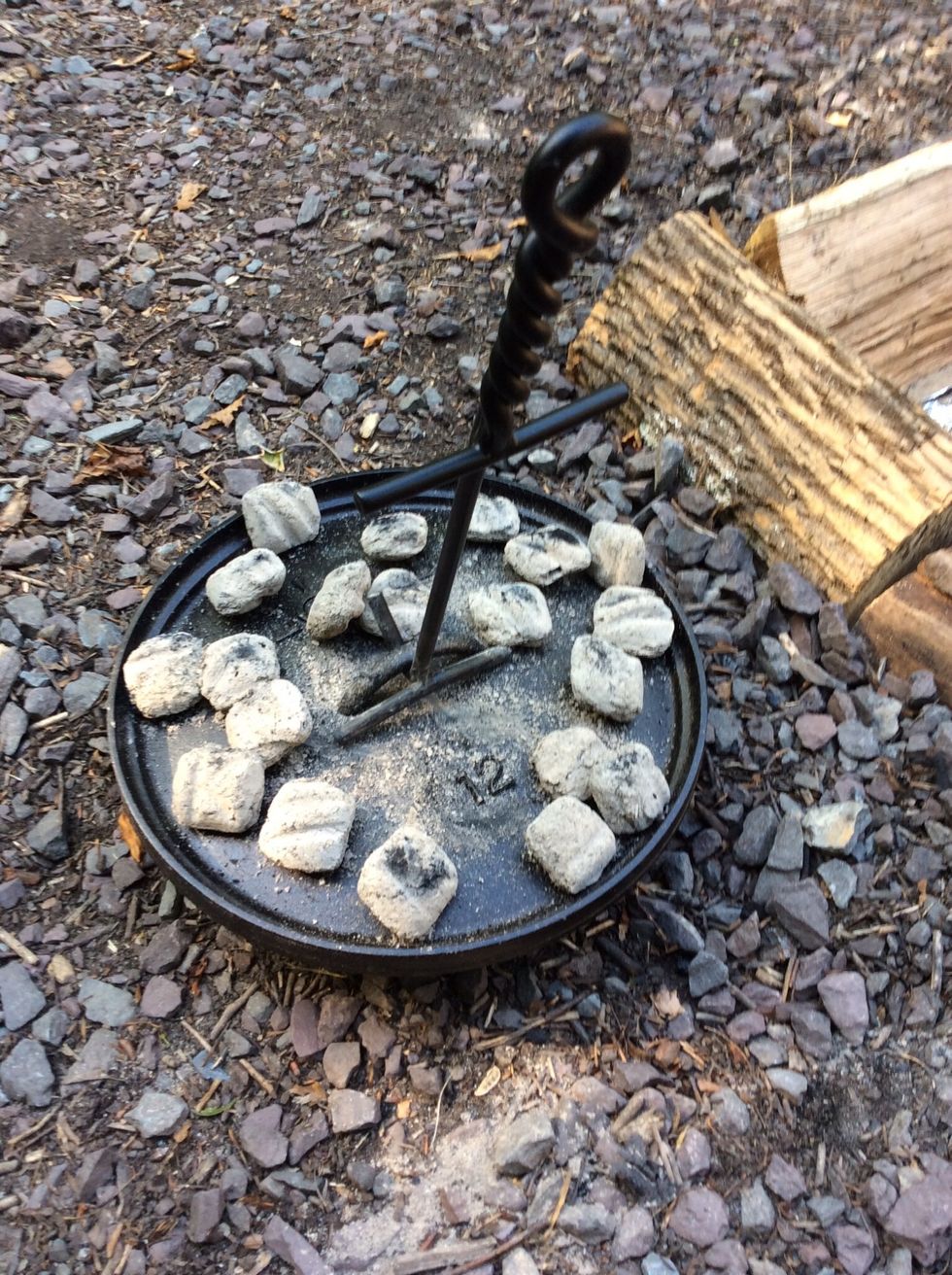 Using a lid lifter, lift the preheated lid and place on top of the Dutch oven.