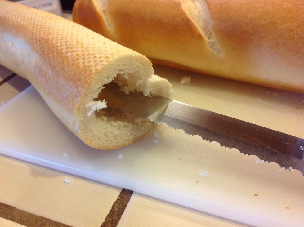 Using a long knife, hollow out baguette.