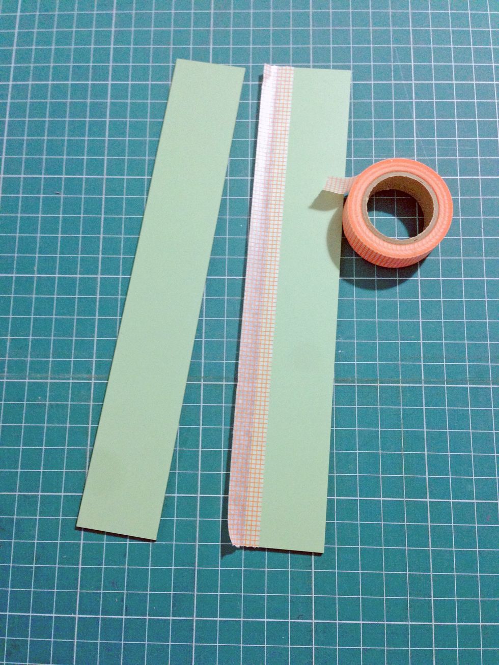 Using a masking tape (or washi tape), tape one side on the reverse side of the mirror...
