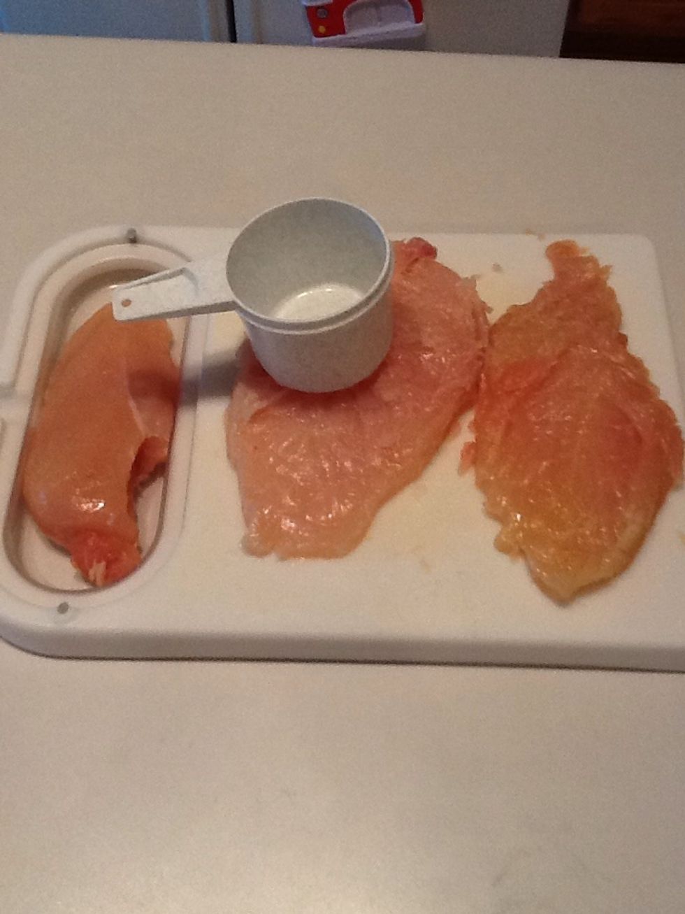 Using a meat mallet (or back of a measuring cup), pound chicken breasts until they are about 1/4 inch thick. Set aside.