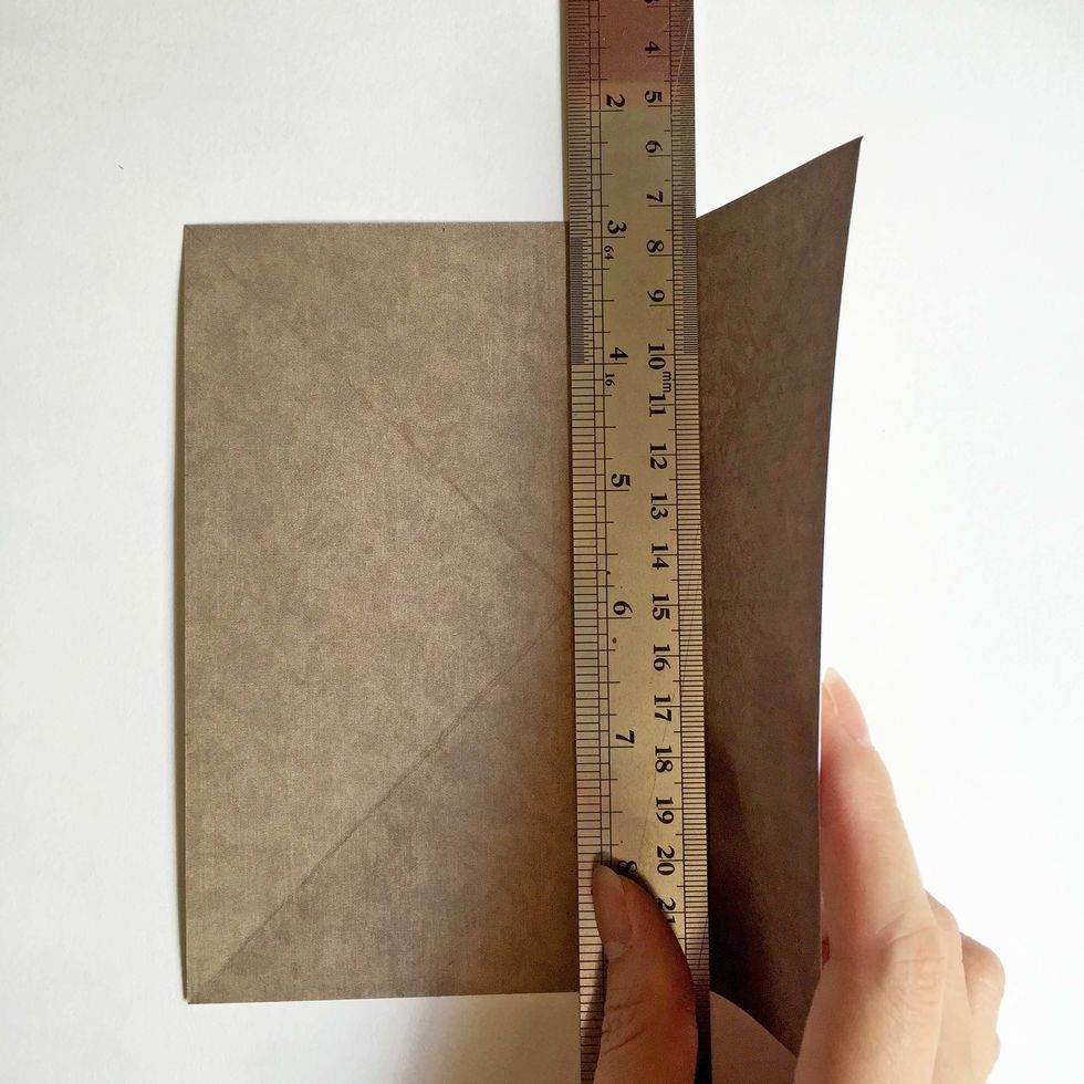 Using a metal ruler as a guide, fold the papers accordingly... You should have 2 folded lines with 3  columns...