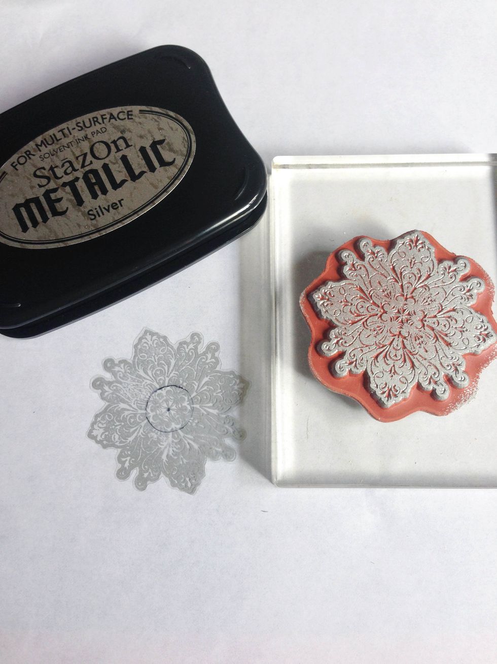 Using a metallic silver StazOn ink, stamp a snowflake image onto a transparency... At the center, mark a 0.5" circle...