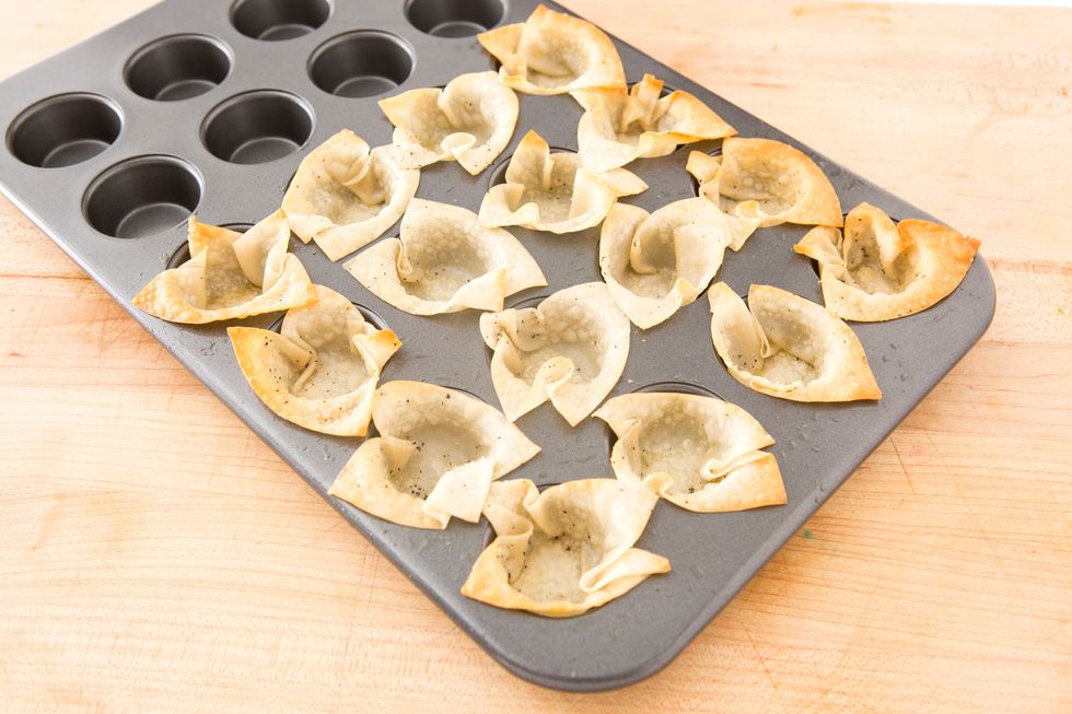 Using a mini muffin pan, press wonton wrappers down into the cups, laying back the corners and pressing the bottoms down to make a defined cup. Bake for 8-10 minutes or until lightly browned.