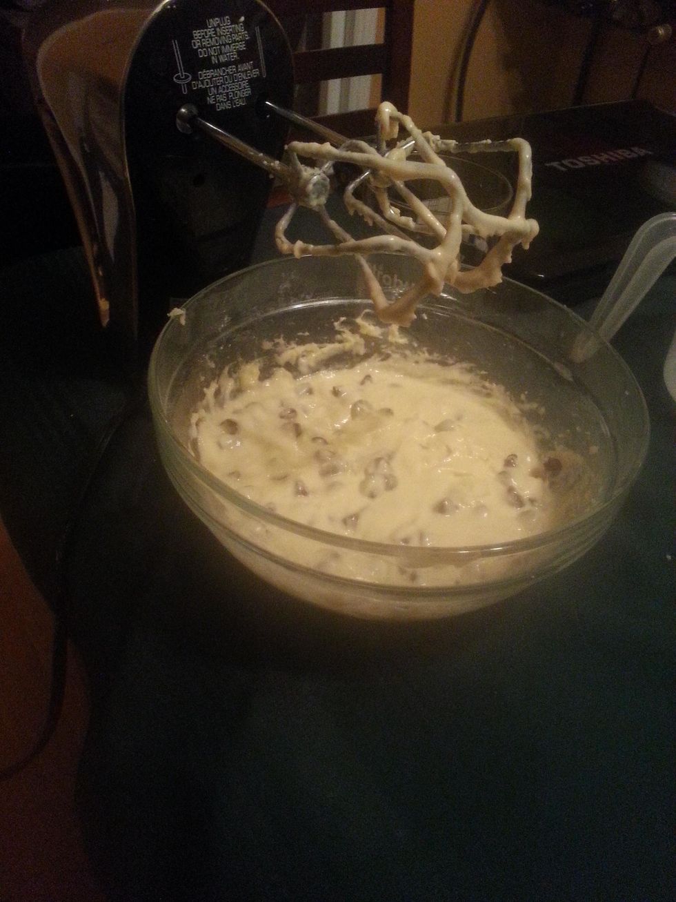 using a mixer, combine the cream cheese and sugar. The, blend in the egg yolks, vanilla extract, salt and flour. Stir in the chocolate chips.