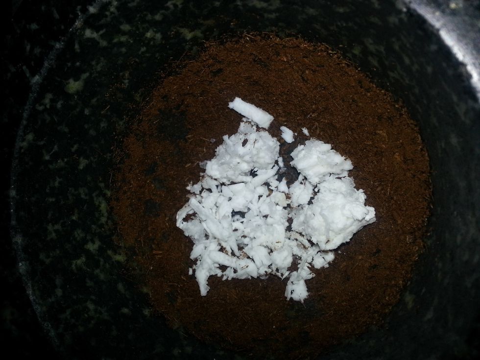 Using a mortar and pestle, finely grind the cumin seeds. Later ass in the grated coconut and continue to grind it to a smooth paste.