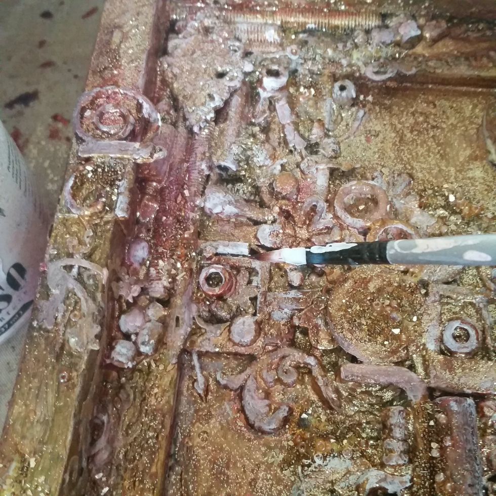 Using a paint brush add some highlights to the top of the bits and bobs with gesso to show the depth and layers of the project.