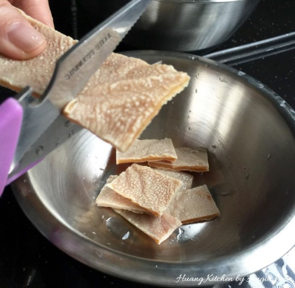 Using a pair of scissors or knife, cut the dried sweet bean curd sheets into thick strips and set aside.