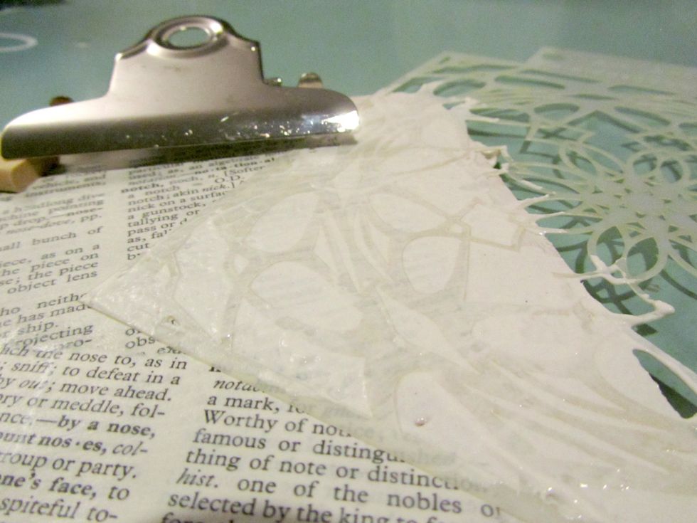 Using a palatte knife spread some Art Anthology Stucco over the stencil.