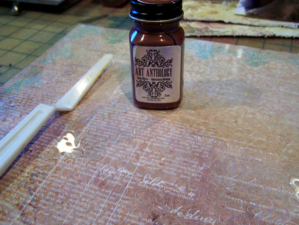 Using a palette knife, Stencil and Stone Effects Copper spread across the stencil on bottom of layout.